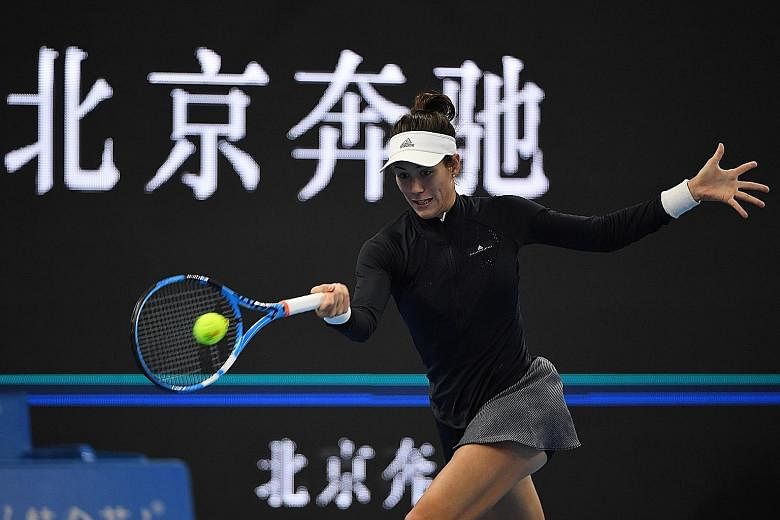 Wimbledon champion and world No. 1 Garbine Muguruza in action at the China Open before her first-round retirement owing to illness yesterday. She had suggested in the tournament build-up that she was not fully fit and promptly lost the first set 6-1 