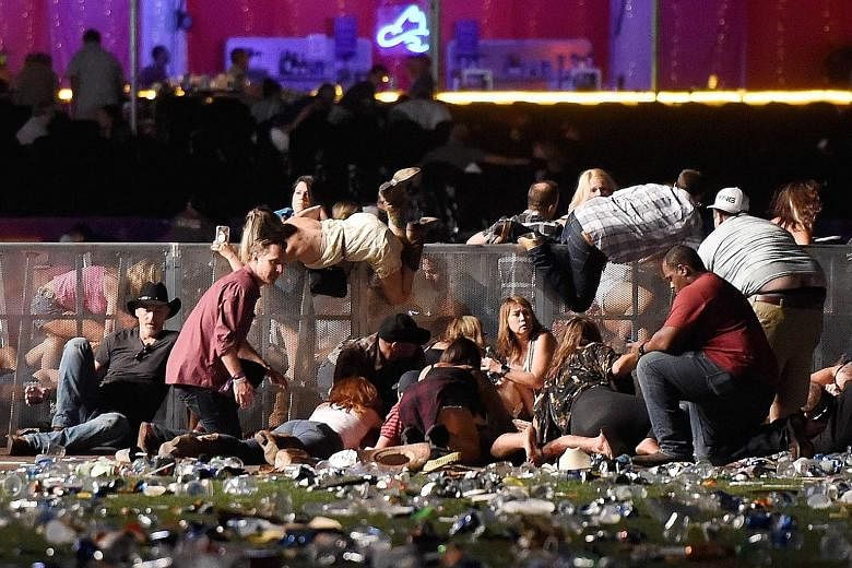 People scrambling for cover after gunfire broke out at the Route 91 Harvest music festival in Las Vegas on Sunday night. The gunman opened fire from the 32nd floor of a hotel. Police said the death toll may yet rise.