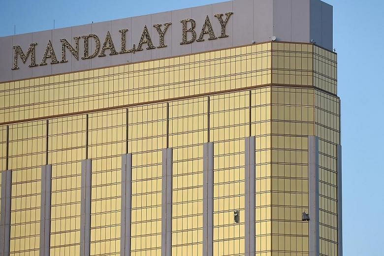 Left: The gunman opened fire from the 32nd floor of the Mandalay Bay Resort and Casino (in background) overlooking the Route 91 Harvest music festival grounds. Above: Broken windows on the hotel's 32nd floor following the shooting. Las Vegas shooter 
