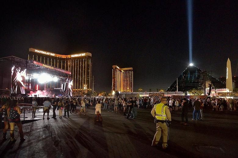 Left: The gunman opened fire from the 32nd floor of the Mandalay Bay Resort and Casino (in background) overlooking the Route 91 Harvest music festival grounds. Above: Broken windows on the hotel's 32nd floor following the shooting. Las Vegas shooter 