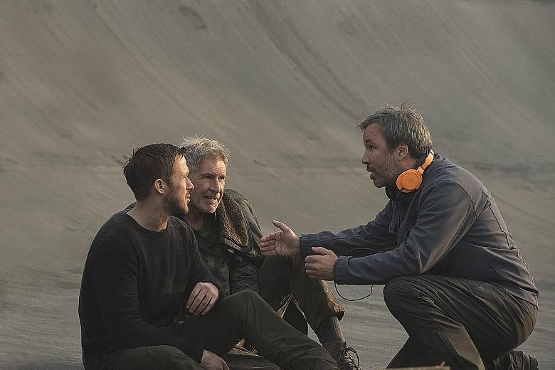 On the set of Blade Runner 2049 are (from far left) actors Ryan Gosling and Harrison Ford, and director Denis Villeneuve.