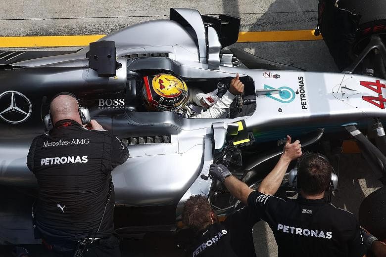 Lewis Hamilton signalling to pit crew during practice at Sepang last week. Both Mercedes cars were behind the Red Bulls and Ferraris during much of the three days in Malaysia and the front runner is clearly concerned despite his 34-point lead over Se