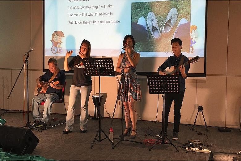 Ms Goh (second from far left) song-signing at the Story Carnival last month. With her are (from far left) Mr Jaffar Sidek, Ms Vivienne Wong and Mr Feng Lee. Telling stories using songs is a way of promoting deaf awareness, said Ms Goh. Ms Lily Goh at