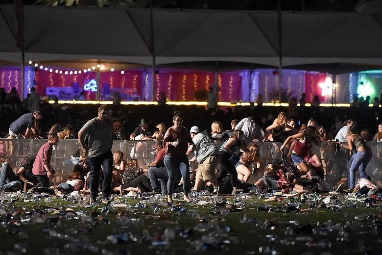 Concertgoers at the Route 91 Harvest country music festival running for safety after a gunman went on a shooting spree from a window at the Mandalay Bay Resort and Casino, about 365m away from the festival site.