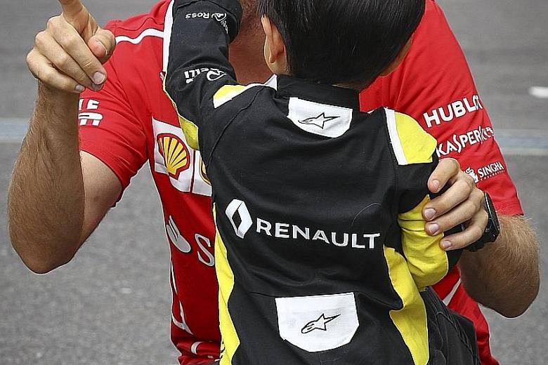 Clockwise from far left: This supporter of former F1 driver Robert Kubica, Ferrari's Kimi Raikkonen and McLaren's Fernando Alonso is clearly no fair-weather fan. Mercedes driver Lewis Hamilton does not sign out when a Sebastian Vettel fan asks for hi
