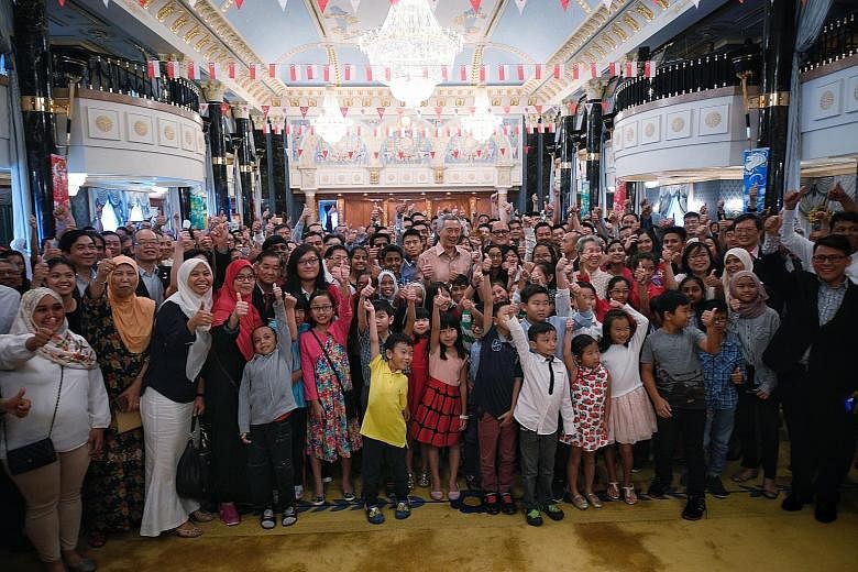 Prime Minister Lee Hsien Loong and Mrs Lee in a group photo taken during their meeting in Bandar Seri Begawan with Singaporeans yesterday. They are there for Sultan Hassanal Bolkiah's Golden Jubilee celebration.