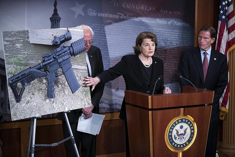 US Senator Dianne Feinstein, with senators Bernie Sanders (left) and Richard Blumenthal, speaking on gun control legislation at a press conference in the US Capitol in Washington on Wednesday. She unveiled a Bill that bans bump stocks, devices that a