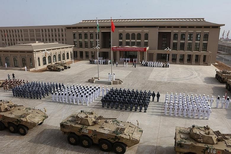 People's Liberation Army personnel at the opening ceremony of China's military base in Djibouti on Aug 1. The army announced the establishment of the logistics support base in July.