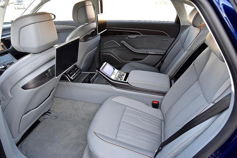 Audi's latest flagship A8 is bigger and smoother, gliding like a yacht over calm waters. Check out its legroom (below).
