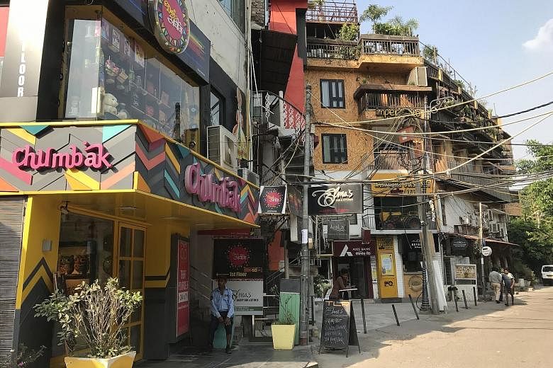 Restaurants line the main lane in Hauz Khas Village, a popular spot for a night out in capital city Delhi. The ruins of a madrasah and tomb complex, which were built around a water tank, in Hauz Khas Village date back to the 14th century.
