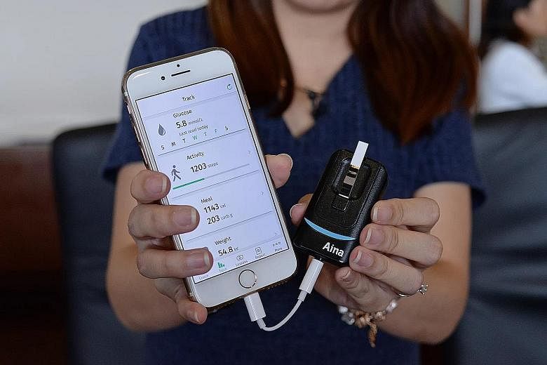 Those using the app in the trial will be given a device (left) that reads blood glucose test strips. The readings are synced automatically from the device when it is plugged to the smartphone app.