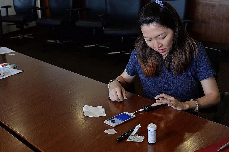 Those using the app in the trial will be given a device (left) that reads blood glucose test strips. The readings are synced automatically from the device when it is plugged to the smartphone app.