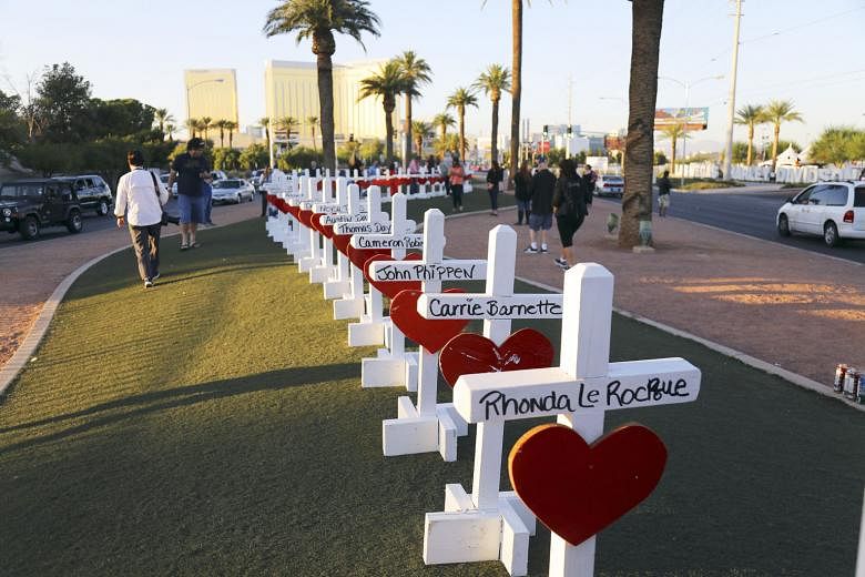 A memorial for the Las Vegas mass-shooting victims near the city's iconic welcome sign.