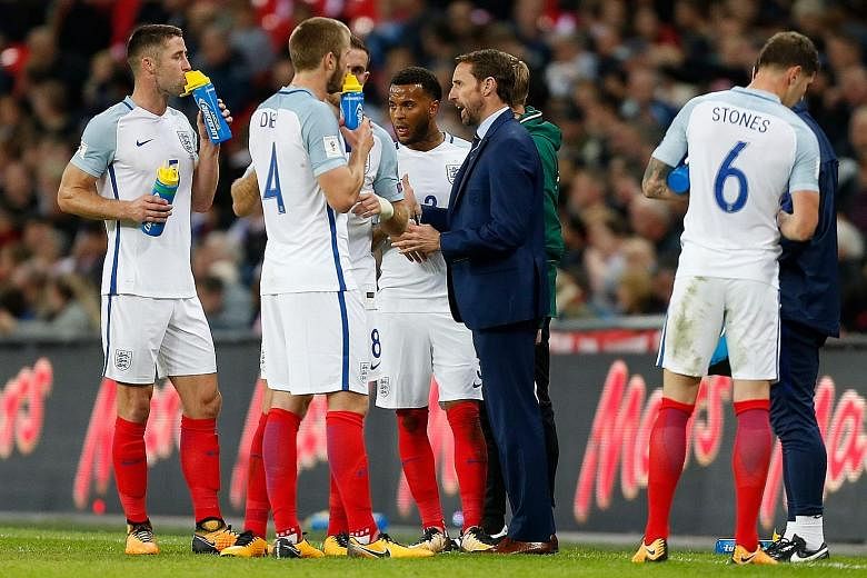 England manager Gareth Southgate giving his players a pep talk during their World Cup qualifier against Slovenia at Wembley on Thursday. They were booed by some supporters and needed a stoppage-time goal from Harry Kane to win 1-0 and secure qualific