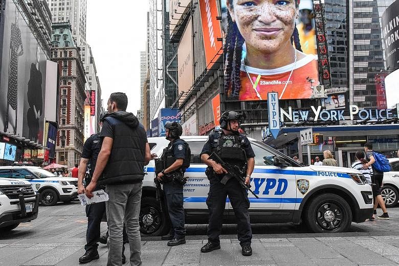 Members of the New York City Police Counterterrorism force standing guard in Times Square in August. US federal officials on Friday disclosed that a plot to detonate bombs in Times Square and the New York City subway system last year had been quietly