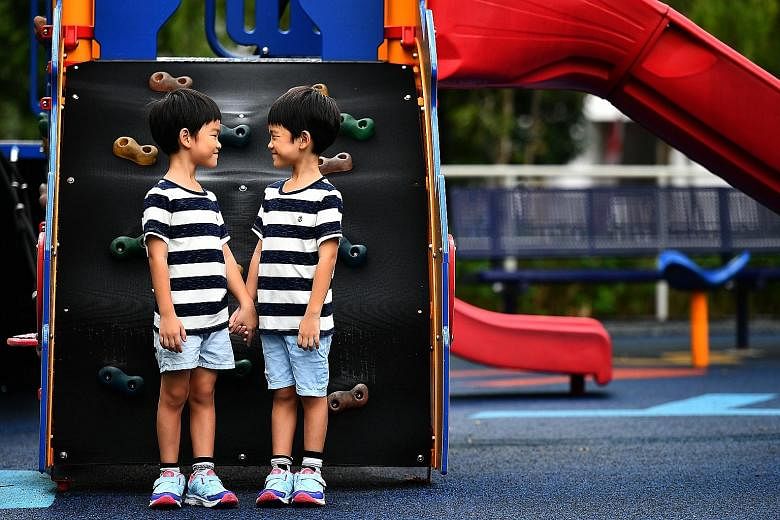 Twins Chua Yong Kang (far left) and Yong Le, five, attend a kindergarten in Sengkang. The boys' mother spends $6,000 a year on their fees, and pays another $1,200 a year for field trips, concert costumes and books for a reading programme.