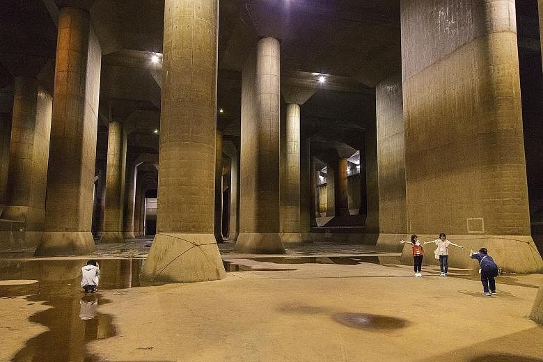 Above: Visitors at the Metropolitan Area Outer Underground Discharge Channel, an anti-flood system in Kasukabe. Left: The control room of the underground site.