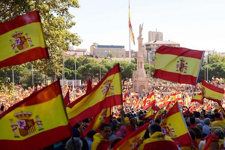 It was a sea of Spanish flags in Colon Square in Madrid yesterday as thousands of demonstrators gathered for a "patriotic" march to keep Spain united as Catalonia threatens to declare independence.