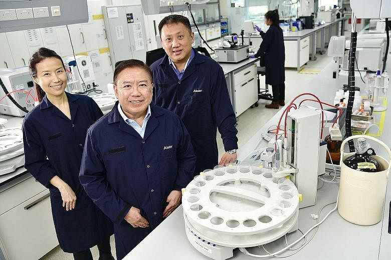 Alcon Manufacturing and Logistics' (from far left) head of human resources Elsie Lim, 46, general manager Mark Chua, 59, and head of replenishment centre Joel Ang, 44.