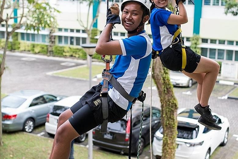Muhammad Hamizan Akid and Zoe Wee participating in an abseiling activity during a PE lesson. Northbrooks' Outdoor Education Programme exposes students to activities such as rock climbing and abseiling, orienteering and kayaking.