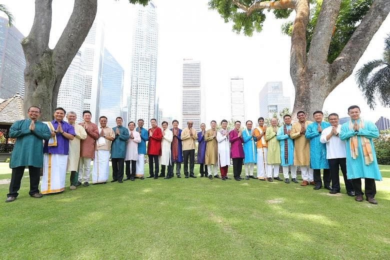 The 24 Members of Parliament, including Deputy Prime Minister Tharman Shanmugaratnam (12th from left), dressed in traditional Indian attire, posing for the Deepavali photoshoot on the Parliament House lawn last Monday. Mr Tharman said the MPs enjoyed