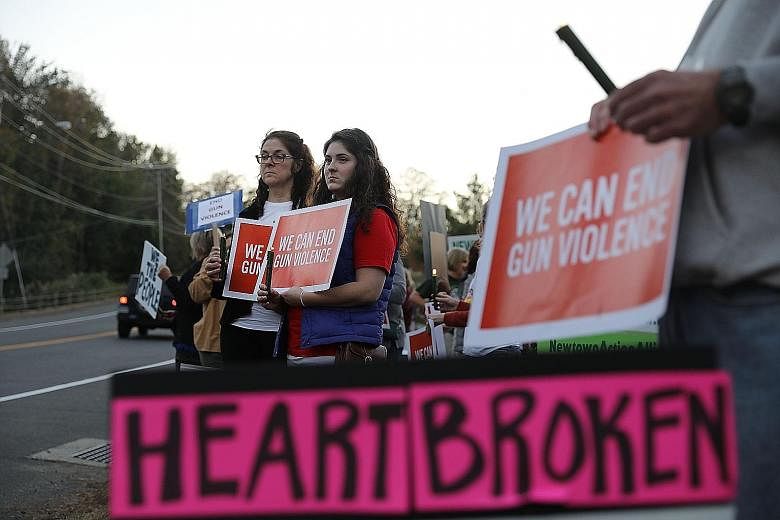 People at a vigil in Connecticut last week for victims of the Las Vegas shooting. It was held outside the National Shooting Sport Foundation to draw attention to gun violence.