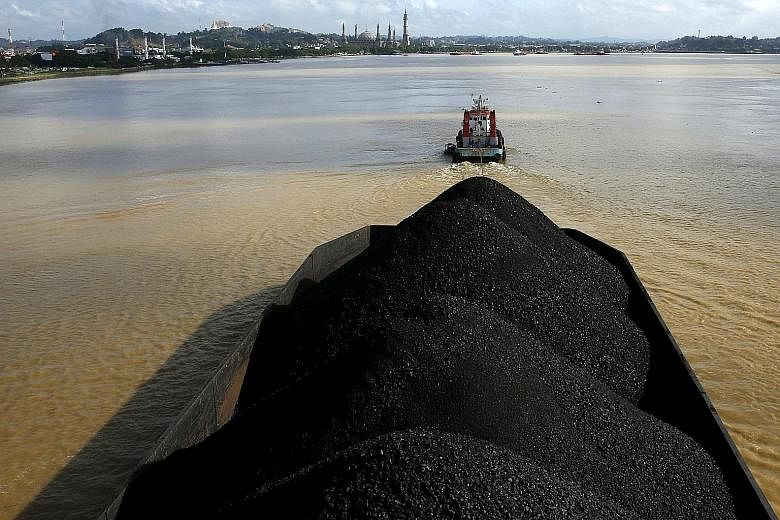A tugboat pulling a coal barge along the Mahakam River in East Kalimantan, Indonesia. Mr Phil Rickard is CEO of BlackGold, which holds the rights to three coal concessions in Sumatra.