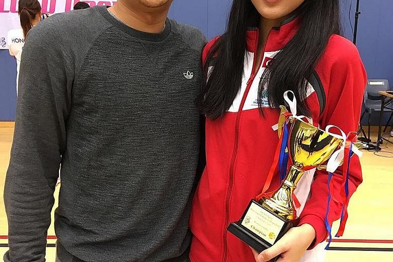 Sabre fencer Lau Ywen with coach David Chan. She has had to switch to a low-intensity style after a stress fracture on her back. Still, she has won a SEA Games gold and now a title in Hong Kong while on the comeback trail.