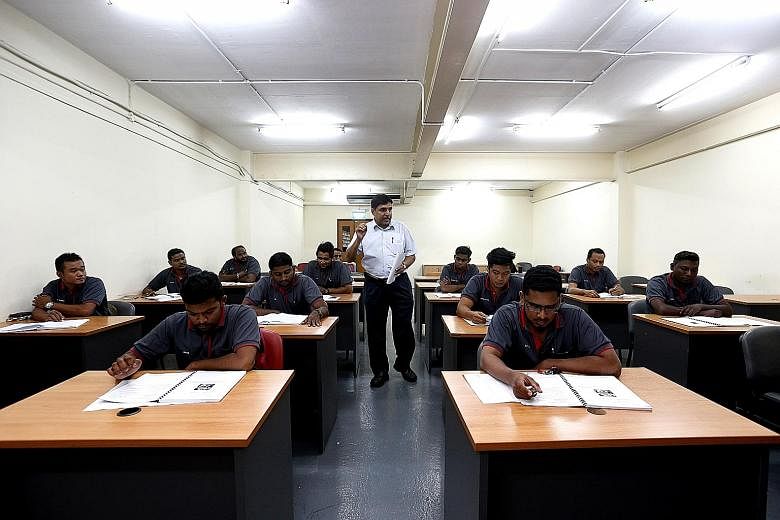 Department manager Karmachand Sahu holding a theory class at Fujitec Singapore. The company offers courses in lift and escalator technology under a train-the-trainer scheme in collaboration with ITE. 