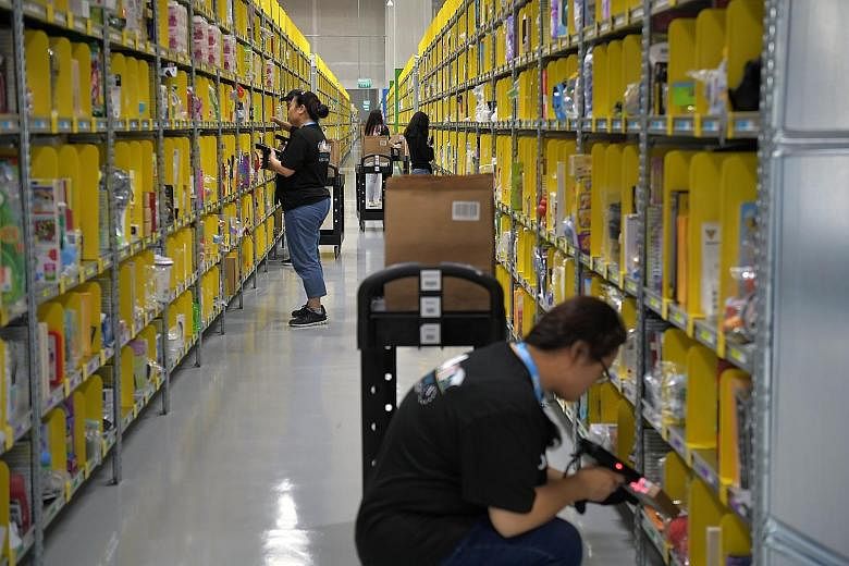 Amazon staff preparing orders at its Prime Now facility in Singapore. The South-east Asian e-commerce market is projected to reach US$88 billion (S$120 billion) by 2025, according to a report by Google and Temasek Holdings.