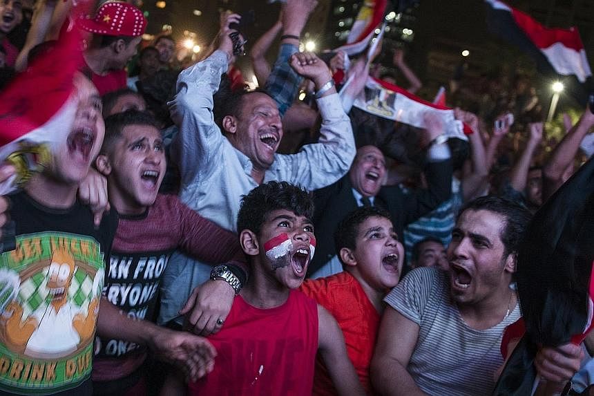 Above: Egypt fans spilling out onto the streets of Cairo after the full-time whistle was blown, following Salah's 95th-minute penalty winner against Congo.
