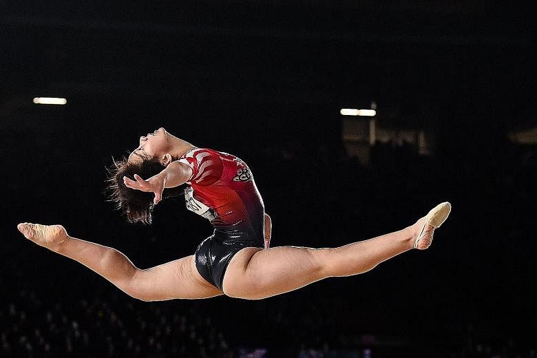 Mai Murakami leaping high during her floor exercise routine at the Artistic Gymnastics World Championships in Montreal. After finishing only fourth in the individual all-around final, she won the gold in the floor exercise, and became the first Japan