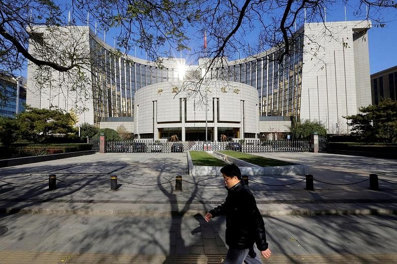 The People's Bank of China headquarters in Beijing. How the central bank sets policy in response to economic data may potentially be recalibrated after the upcoming Chinese Communist Party transition, says Mr M. K. Tang, senior China economist at Go