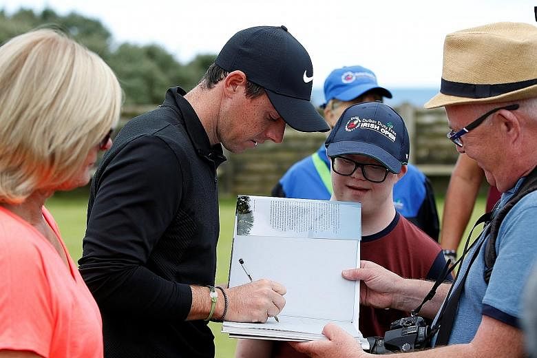 Rory McIlroy signing an autograph in Portstewart, Northern Ireland. The golfer revealed last week that he has disliked Roy Keane ever since the former Irish midfielder turned down his boyhood request for an autograph.