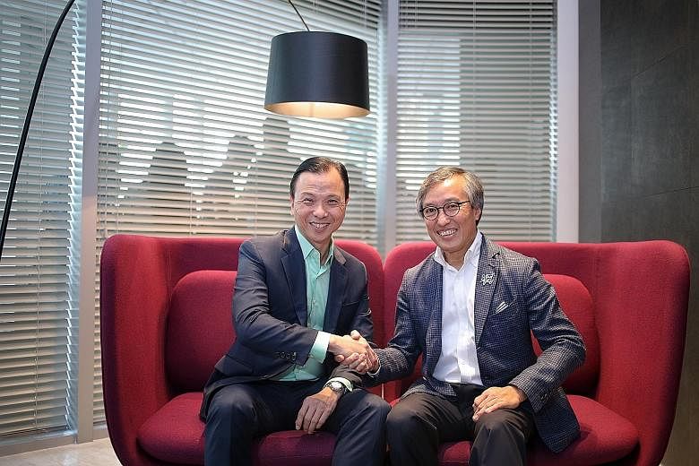StarHub chief executive Tan Tong Hai (left) with OCBC chief operating officer Ching Wei Hong. The firms believe collaboration between different industries is a way to beat the competition. OCBC's orchardgateway branch combines its financial services 