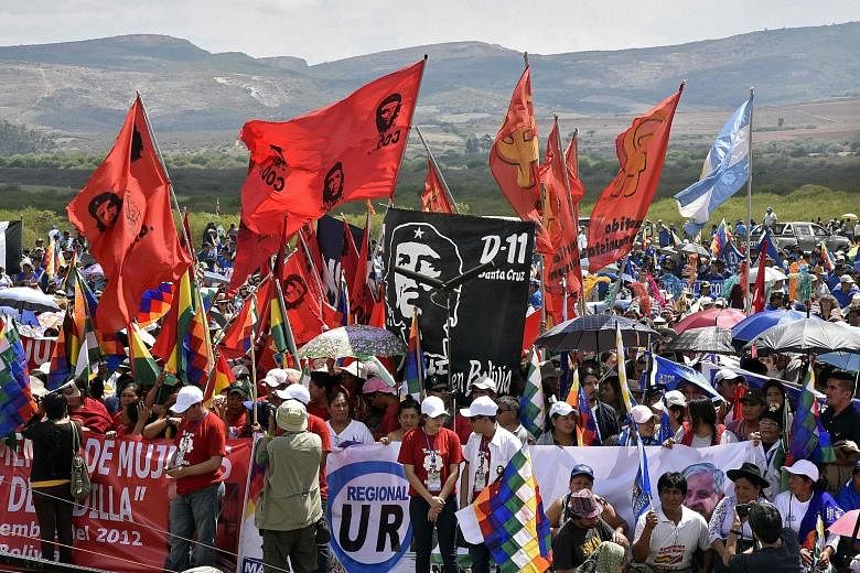 People commemorating the 50th anniversary of Argentine-born guerilla leader Ernesto "Che" Guevara's death at a ceremony in Vallegrande municipality, southern Bolivia, on Monday. The 39-year-old Guevara was captured and executed by a CIA-trained unit 