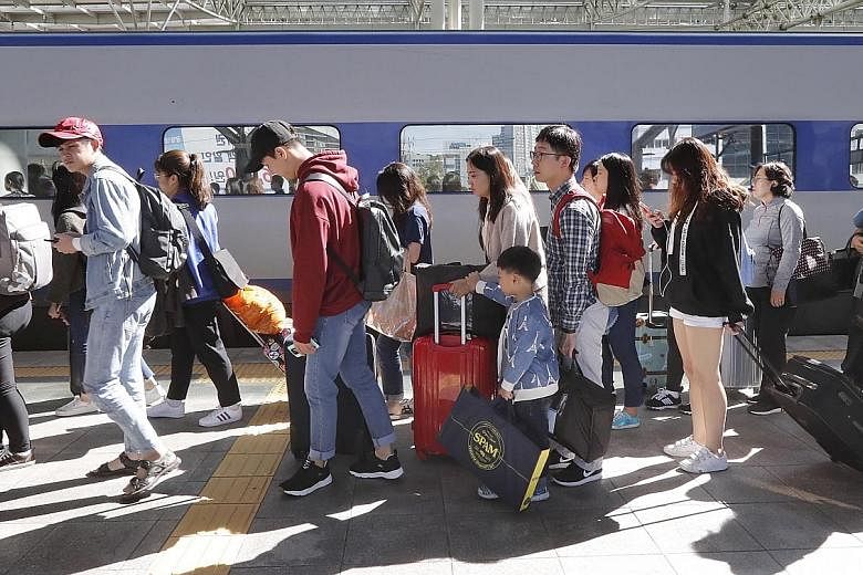 South Koreans at Seoul Station during the Chuseok holiday last Saturday. The long festive period, which began on Sept 30, saw record numbers travel overseas and within the country. The break was also aimed at boosting domestic spending.