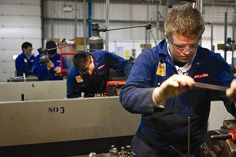 Apprentices working at a BAE Systems site in Warton, Lancashire, in Britain. BAE said it needed to reduce the workforce at this site and Samlesbury, where it makes parts for the Typhoon jet.