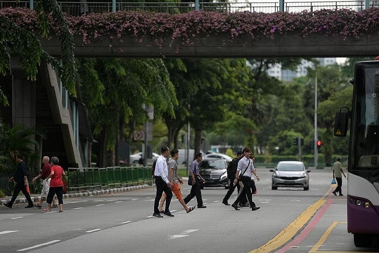 People jaywalking in North Bridge Road yesterday, despite having an overhead bridge and pedestrian crossing nearby. There were 161 accidents in which pedestrians jaywalked in the first six months of this year, up from 133 in the same period last year