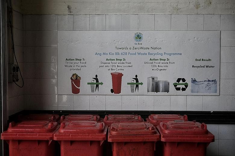 Bins for food waste at the market and food centre at Block 628 in Ang Mo Kio Avenue 4. The pilot of a food digester here has "performed according to expectations", said the National Environment Agency. The food digester in operation at Block 628 in A