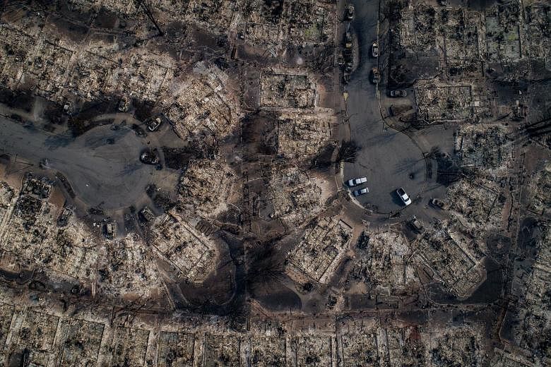 An aerial view of homes burnt by wildfire in a Santa Rosa neighbourhood on Tuesday. Flames from 17 blazes have blackened over 46,500 ha in California since fires broke out last Sunday.