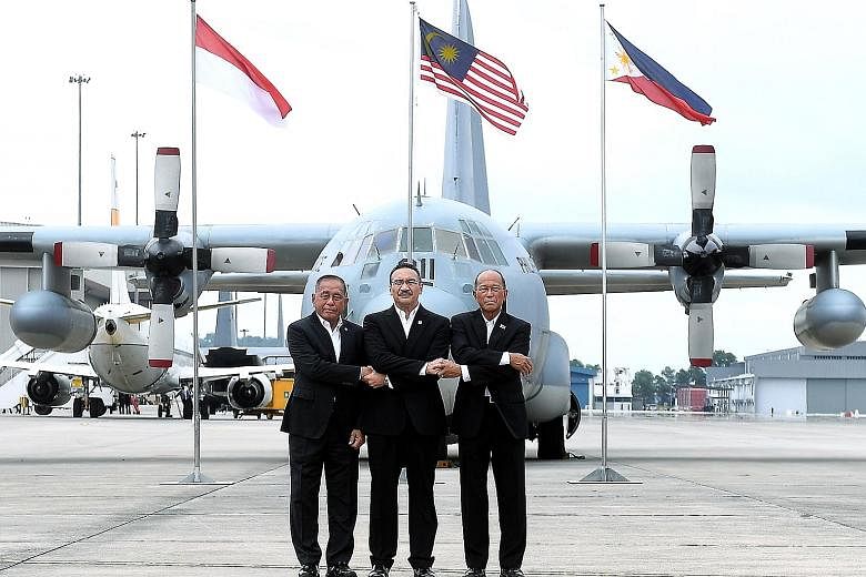 Malaysian Defence Minister Hishammuddin Hussein (centre) with his Indonesian counterpart Ryamizard Ryacudu (far left) and Philippine counterpart Delfin Lorenzana at the launch of the trilateral air patrols over the Sulu Sea yesterday in Subang, Selan
