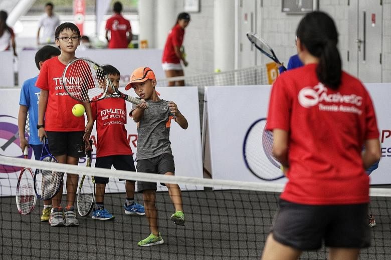 Eight-year-old Jerry Chea Ree making a forehand return during the Singapore Tennis Festival at the Sports Hub yesterday. These and other activities are part of the experience tours that SportSG will conduct during the week of the WTA Finals.