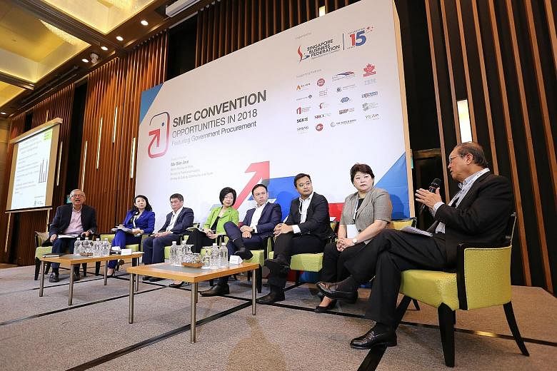 Senior Minister of State for Trade and Industry Sim Ann (fourth from left), at a panel discussion with SBF representatives, reassured SMEs that services would not be affected by the merger.