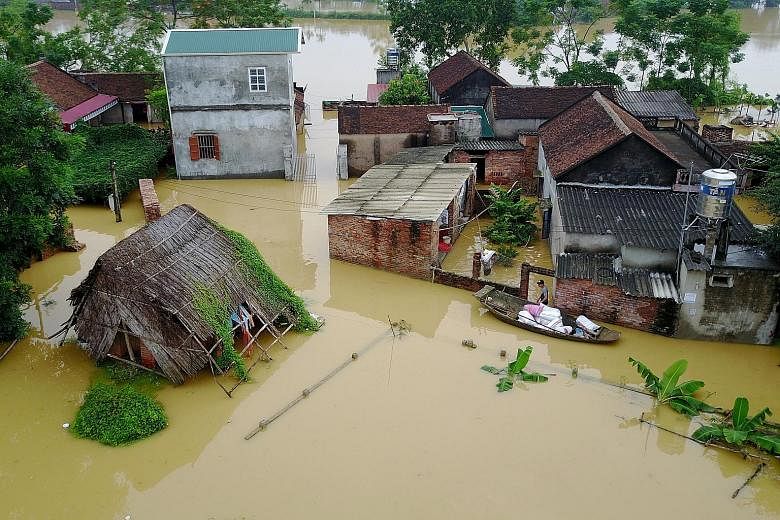 Houses in Hanoi affected by the floods. About 317 homes in the country have collapsed in floods and landslides this week, while more than 34,000 houses have been submerged or damaged.