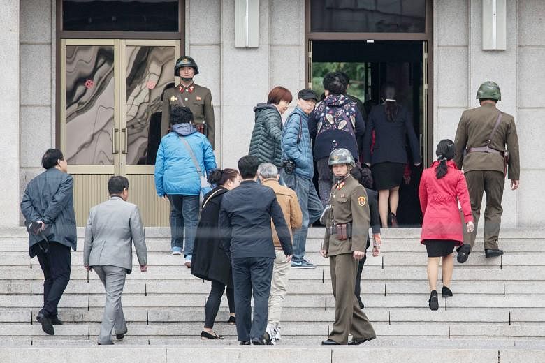 Tourists at the truce village of Panmunjom, situated at the military demarcation line separating North and South Korea. Talk of German reunification in the late 1980s resulted in South Korean commentators also thinking about scenarios for Korean reun