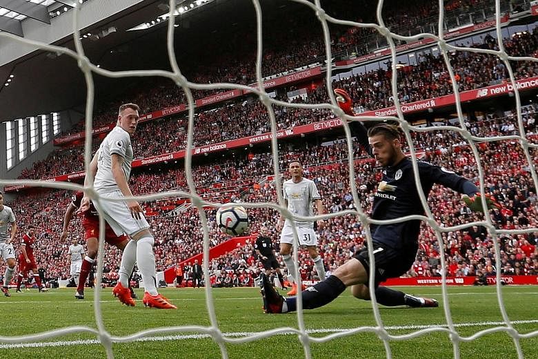 Manchester United's Phil Jones (left) watches as his goalkeeper David de Gea makes a wonder save against Liverpool's Joel Matip. It was the highlight of the match.