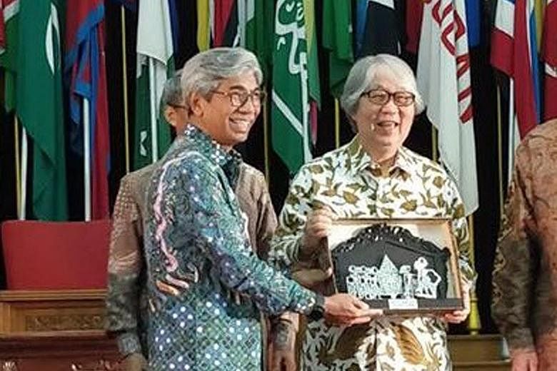 Professor Tommy Koh receiving the award from Indonesia's Deputy Foreign Minister H. Abdurrahman Mohammad Fachir, in Bandung, West Java yesterday.