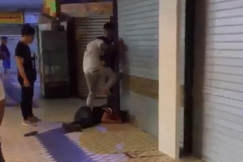 The man in the white top is seen stomping on the victim's face repeatedly in the video. He punches another man standing nearby when the latter appears to try to intervene.