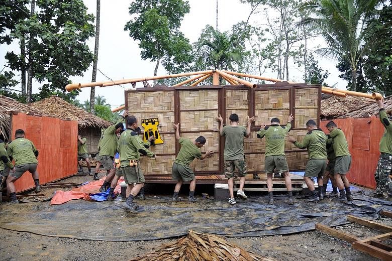 Philippine soldiers building houses for families displaced by the conflict in Marawi. So far, 47 civilians have been killed and large parts of the city have been destroyed.